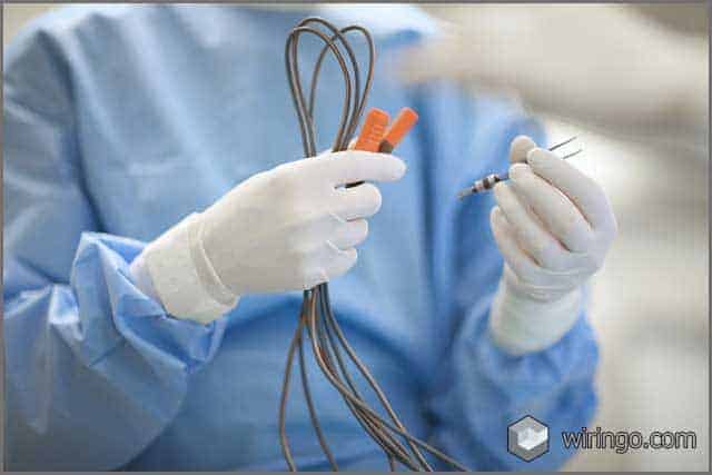 Surgeon's hands preparing coagulation wires