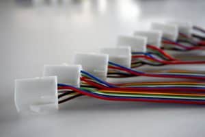 Wire harnesses with plastic connectors